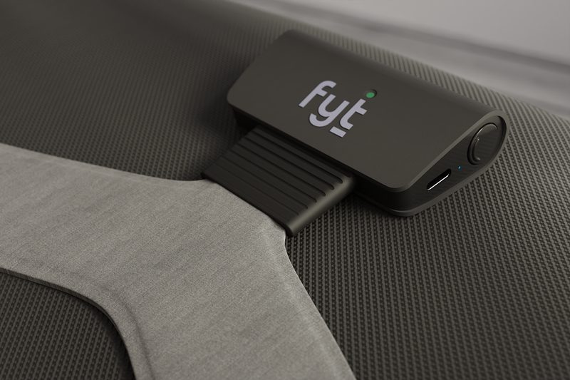 Close-up of the slim Fyt sensor module on a fabric office chair seat